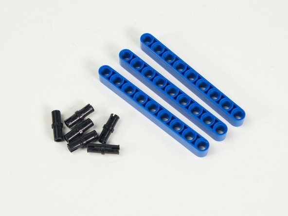 Add two black pins to each blue beam.