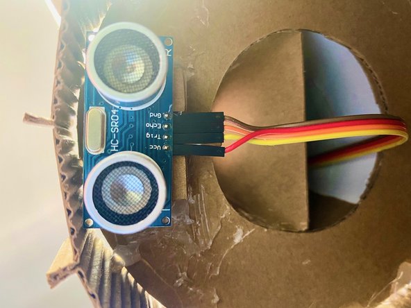 We glued the distance sensor in place inside the base, just under the front lip.