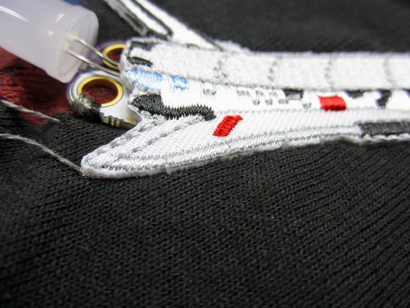 If you're using a Shuttle patch, sew it on now using regular thread.