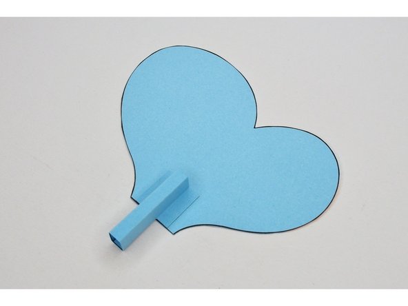 Glue the tabs of the wing holder onto the wing.