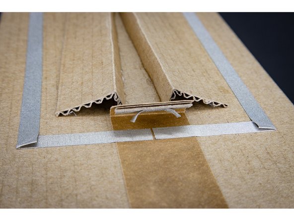 Tape a small rectangle of cardboard to a larger piece to create a flap that looks like a &quot;draw bridge&quot;.