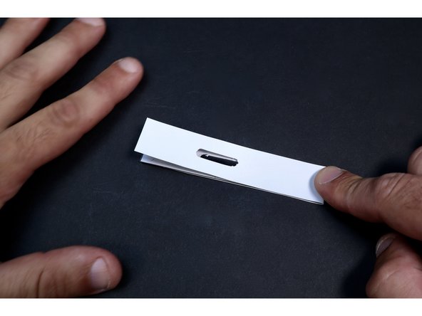 Fold the shape in half as shown on the dotted line that crosses the middle slot.