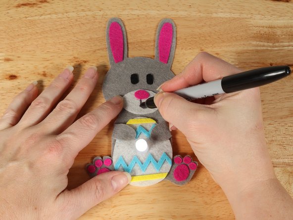 If you are using Elmers or Tacky glue, you will need to use something to hold the paws in place until it dries. Binder clips work well for this.