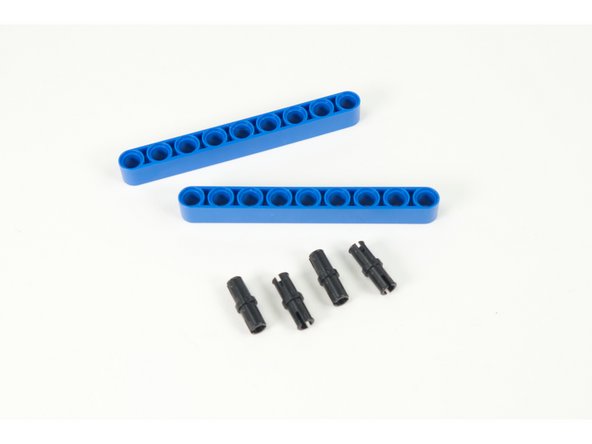 We'll use two 9 hole beams and four pins to raise up our servos to the correct height on the frame.