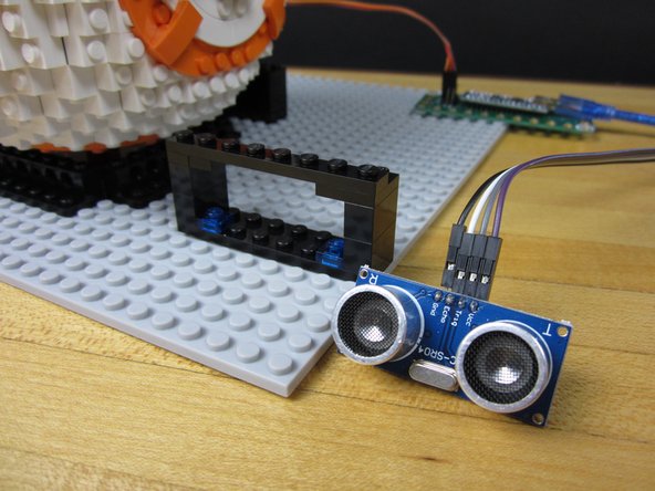 Start with a 2x8 plate, attach some 1x2 bricks onto the side, two L shaped plates on the top edge, and a 1x8 across the top. Use a couple of 1x1 plated on the bottom (blue in our design).