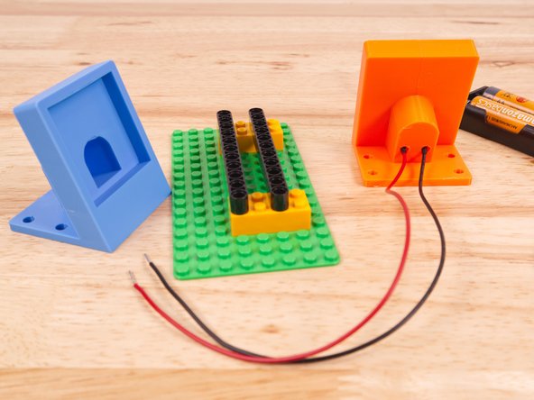 To permanently hold the Voltmeter in place you can add a piece of double-sided foam tape (or a dab of hot glue) behind it.