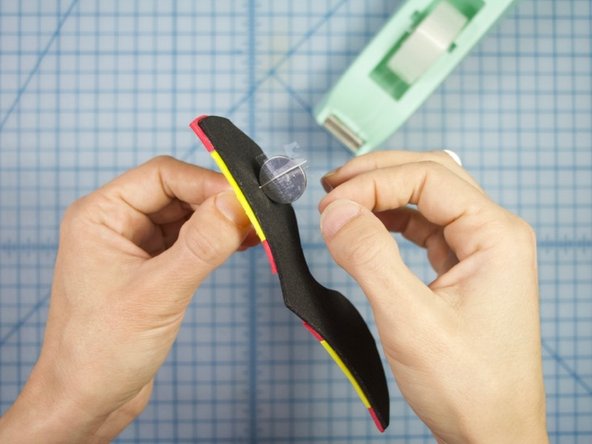 Once you have a lit up LED, wrap a long piece of tape horizontally around the battery and legs to hold them together.