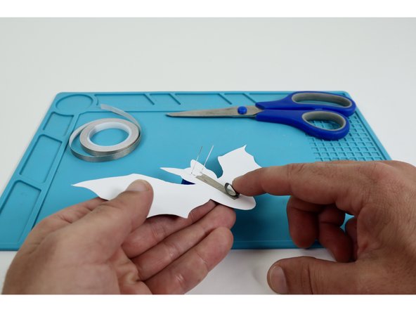 Place that tape loop atop the center of the taped area that is now atop the Long LED Legs.