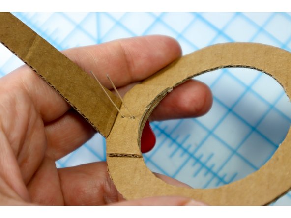 Thread the LED through the holes, aligning it with the frames to glue the temples in place.