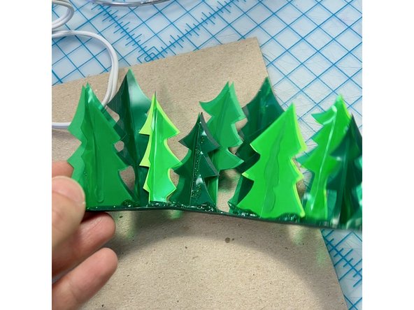 I made a treeline with cardstock and green acetate.