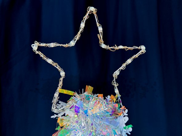 Place the star on top of your tree and watch it shine! (If you're placing the star on a real tree, hide the Bit Board in the branches of the tree. )