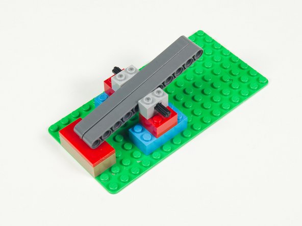 Check the positioning by placing the lever mechanism on the support bricks.