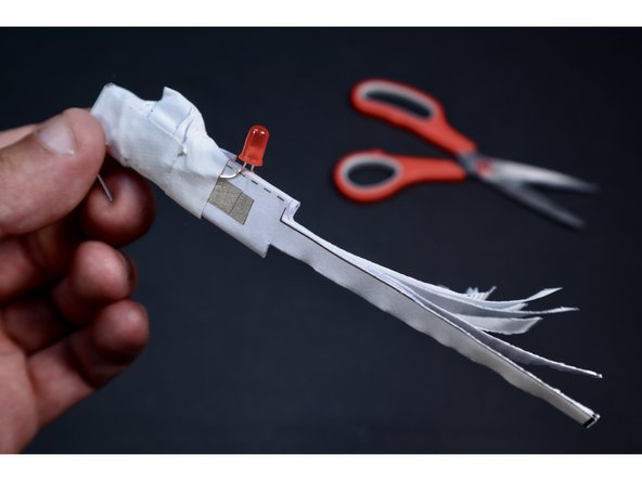 With a scissors, carefully trim along the template lines leaving you with a frilly, narrower section.