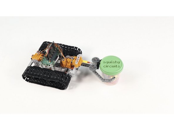 Create some fun challenges, like grabbing a cup or a can and moving it to a new location.