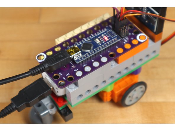 The simplest way is by plugging in the USB Power Bank and letting your robot start to roll forward. If you put your hand in front of it, it should back up, turn, and then move forward again. (Don't let it roll off of a table!)