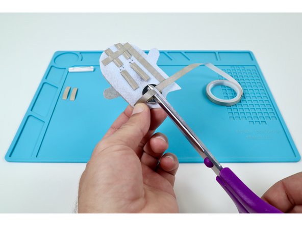 Measure and cut three final pieces of Maker Tape as shown in the photos at left. These pieces will be used to create the path leading from the Long LED Legs back to the top of the battery.