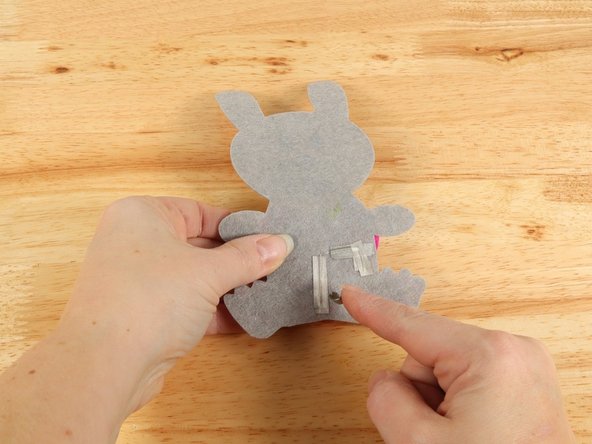 Make a loop of tape (sticky side out) using a short piece of Maker Tape, and stick it atop the end of the path coming from the short (Negative) LED leg.