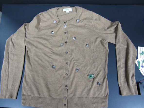 We find it really handy to sew down your electronics using REGULAR thread before using the Conductive Thread.