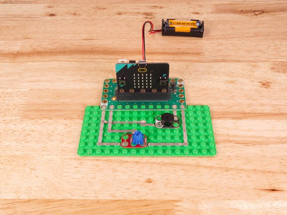 The Piezo will connect to Pin 8 and to Ground (GND) BUT! We're going to use the &quot;gutter&quot; between the LEGO baseplate studs so we can have two layers of tape that do not touch.