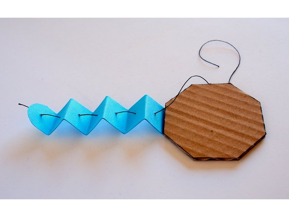 Only glue the last folded section of the tentacle (the one without a hole)