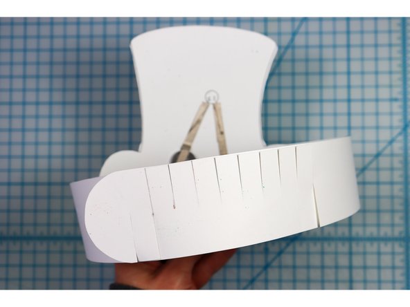 Interlock the slits in two places to create the size that works for your head.