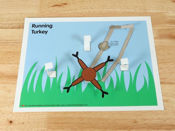 Add a square of double-sided foam tape onto the shaft of the motor, and then stick the legs to it.