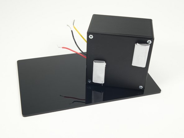 We added two large loops of tape to the button enclosure to stick it down to a plate.