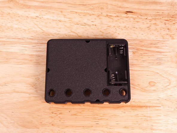 There are a few half-circle cutouts along the edges to allow you to insert a tool and pry the back off if needed.