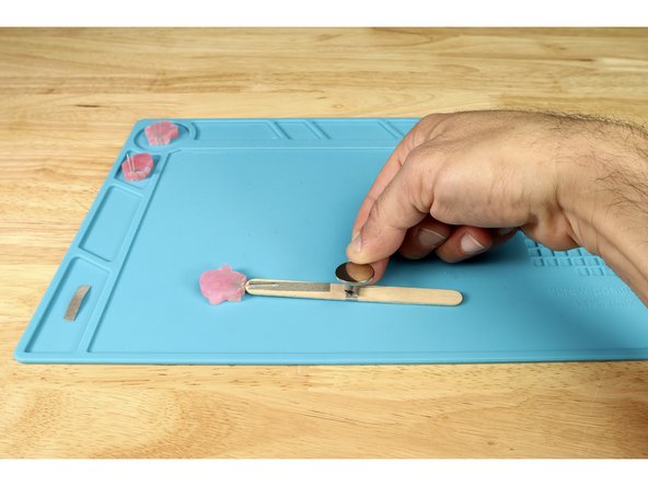 Now, stick the battery atop the tape loop so that the positive (+) side is facing UP.