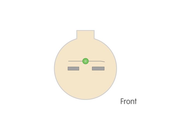 We'll start by placing our LED on our ornament just above the center, with the positive leg on the right side.