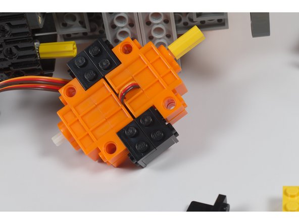 With the two servo motors connected you can attach the entire assembly to the bottom of WALL-E.