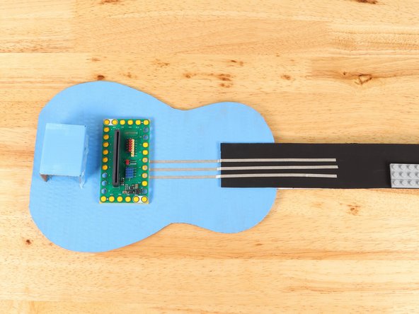 Using 1/8" Maker Tape, adhere the end of the Maker Tape to the center of the stud underneath Pin 13 of the Bit Board.