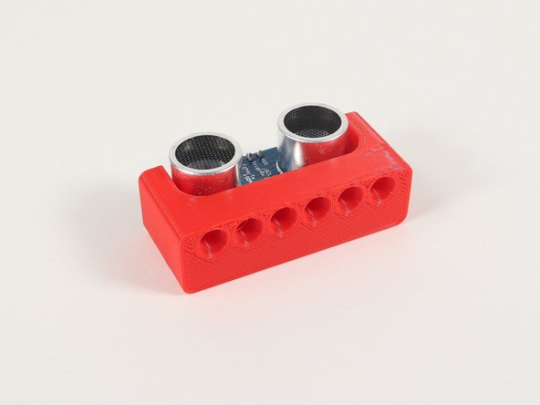 The Ultrasonic Distance Sensor slides into two slots on the Holder so the four connection pins on the Sensor are at the top so we can easily add jumper wires.