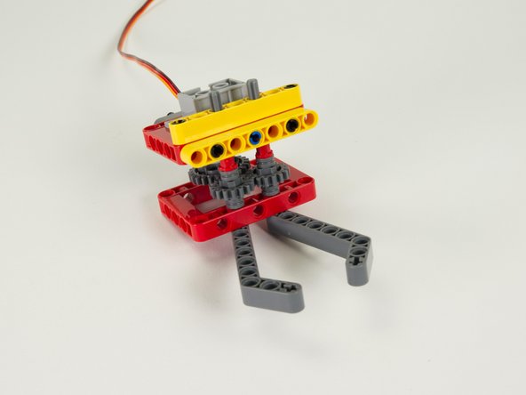 Make sure the large gear on the servo meshes properly with one of the small gears on the bottom assembly.