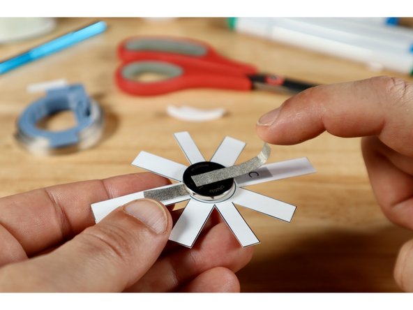 Measure, cut, peel, and stick a Maker Tape path that can reach from the top of the battery, down to where path "C." ends on the ring template.