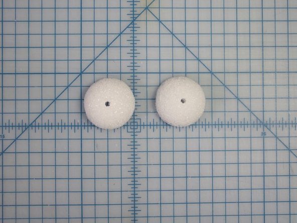 Use a dowel or another type of round stick (like a pencil) to make a hole in the center of each eye.