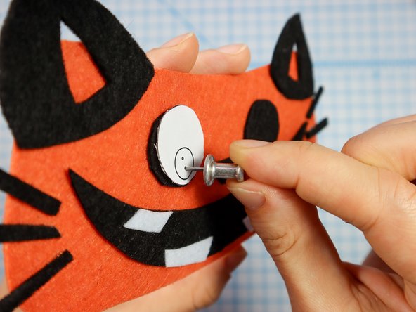 Use a push pin to make two holes for the LED's legs. When the push pin is inside the felt, rotate it around a bit to make the hole larger and easier to see.