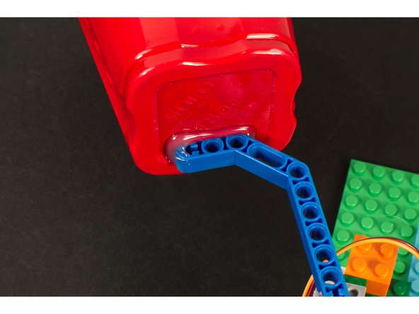 We hot glued a plastic drinking cup to a LEGO Technic Beam.