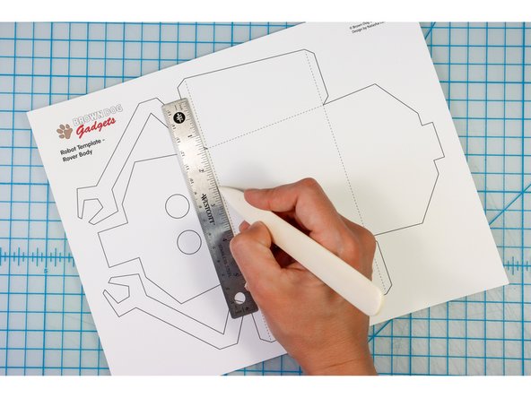 Score the paper along the dotted lines.