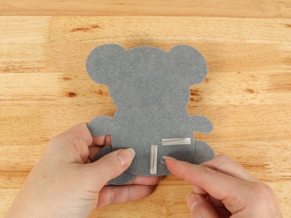 Make a loop of tape (sticky side out) using a short piece of Maker Tape, and stick it atop the end of the path coming from the short (Negative) LED leg.