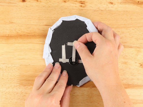 Add Maker Tape to connect the top (Positive) side of the battery to the Positive LED legs path above.