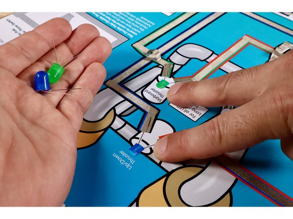 Measure, cut, peel, and stick a small 1/2&quot; piece of Maker Tape to each of the motor wires as shown.