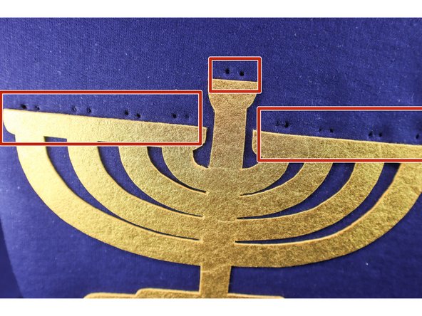 Poke two holes in the sweatshirt in the location of each candle as shown.