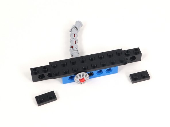 Add 1x2 plates to each end of the 1x12 brick with holes.