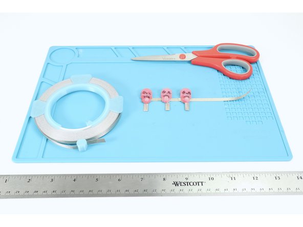 Now cut another 6&quot;-7&quot; section of Maker Tape and lay it over the top of the lower positive LED legs, connecting THEM in the same way you had connected the upper legs.