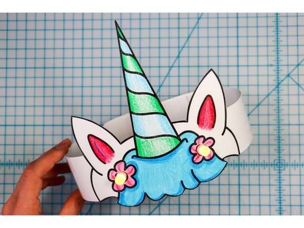 Cut out the side strips and tape them to the hat with the slits facing up on one side and down on the other.