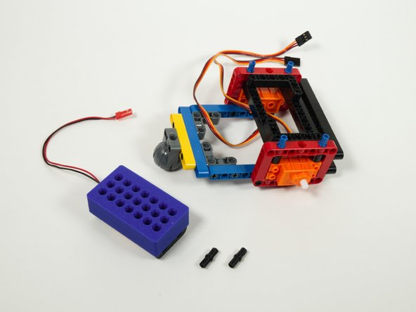 You'll need two black pins to attach the battery holder to the back of the rover.