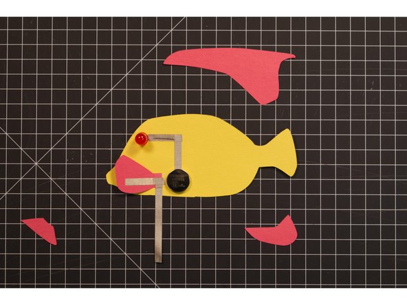 Add another piece of Maker Tape, connecting to the first piece, and running down and around to the back of the fish.