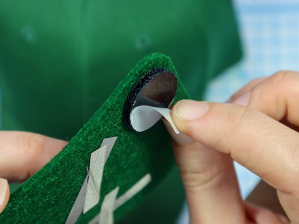 Then, peel the paper backing off of the other side and stick the design to the hat.