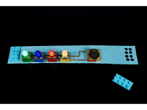 Using the circuit diagram as reference, press the Crazy Circuits components into place atop the bricks as shown.